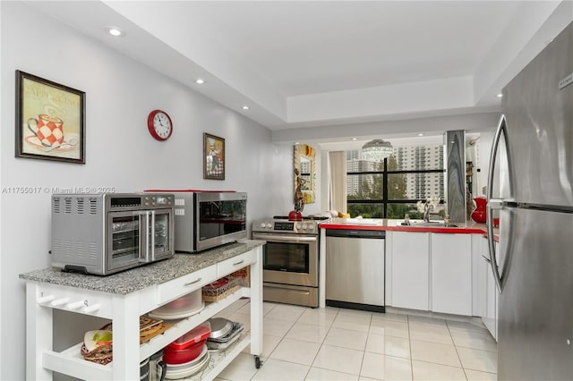 kitchen with open shelves, a sink, white cabinetry, stainless steel appliances, and light tile patterned flooring