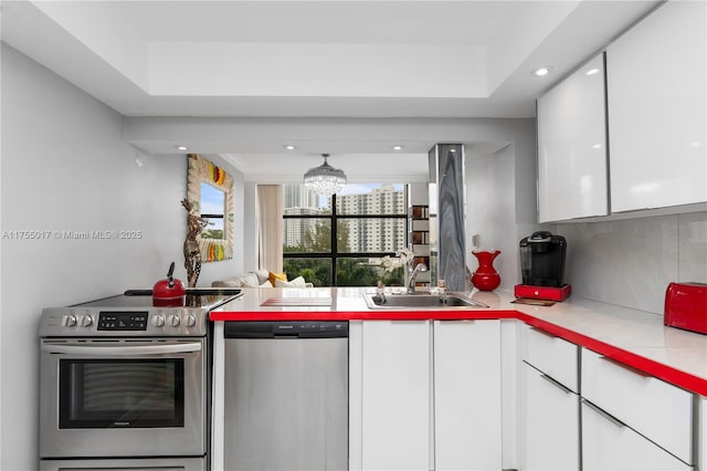 kitchen with white cabinets, stainless steel appliances, modern cabinets, and a sink