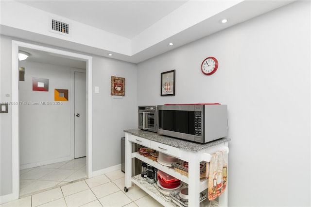 interior space with recessed lighting, visible vents, baseboards, and light tile patterned floors