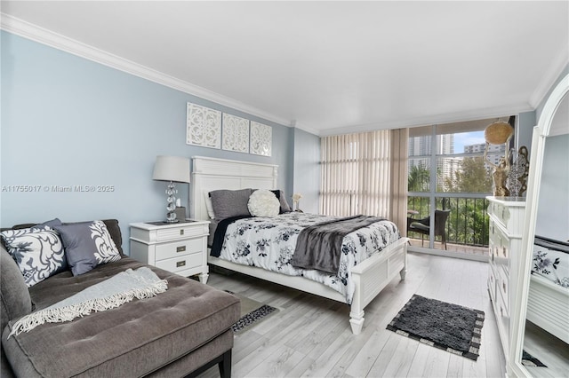 bedroom with floor to ceiling windows, light wood finished floors, and ornamental molding