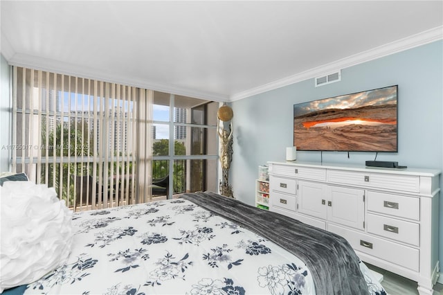 bedroom featuring visible vents and ornamental molding