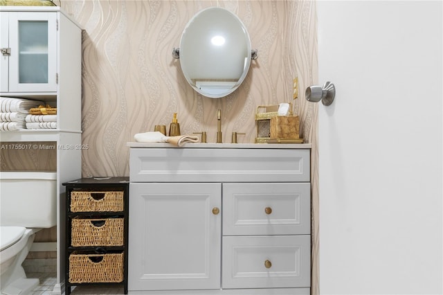 bathroom featuring vanity and toilet