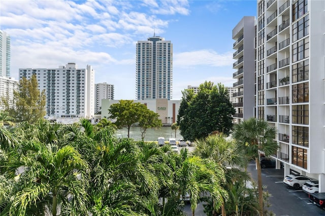 view of property featuring a city view and uncovered parking