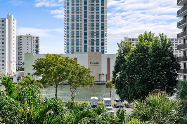 view of property featuring a water view and a city view