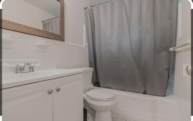 bathroom featuring toilet, vanity, tile walls, and shower / tub combo with curtain