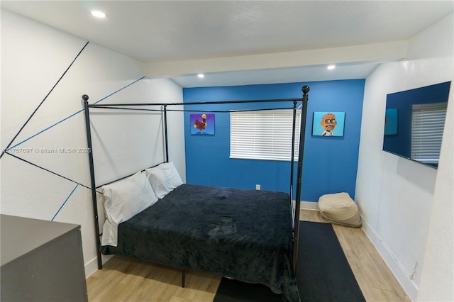 bedroom with recessed lighting, baseboards, and wood finished floors