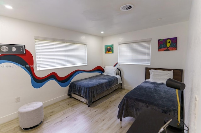 bedroom featuring recessed lighting, visible vents, baseboards, and wood finished floors