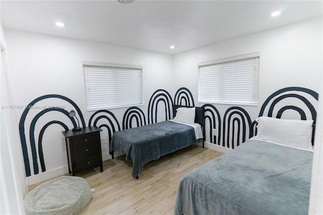 bedroom featuring wood finished floors and recessed lighting