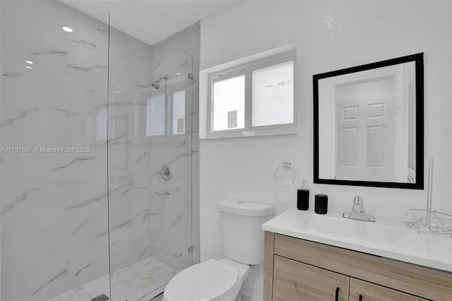 full bathroom featuring toilet, vanity, and a marble finish shower