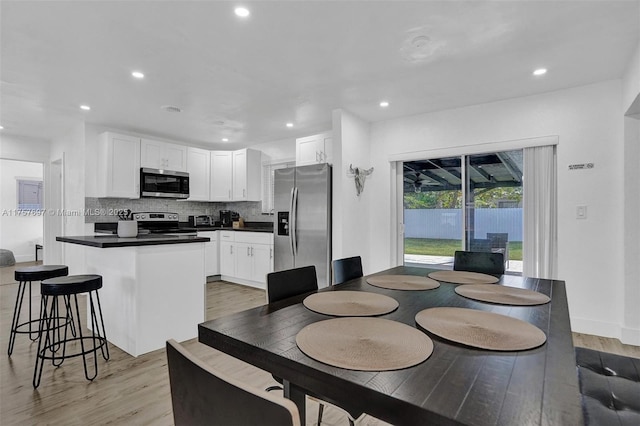 dining area featuring baseboards, recessed lighting, and light wood-style floors