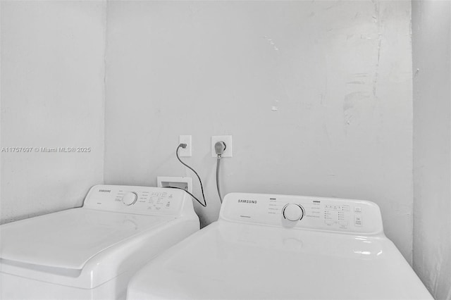 clothes washing area featuring laundry area and washer and clothes dryer