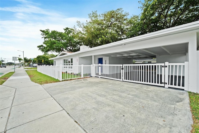 exterior space with a fenced front yard, a gate, and a chimney