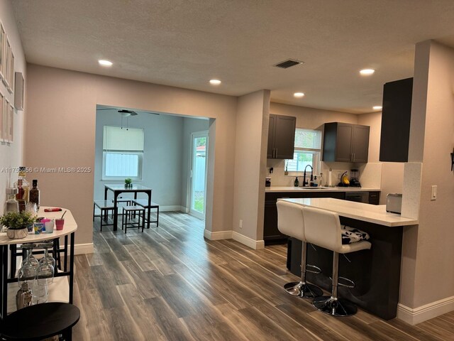 4161 SW 56th Ave, Davie, FL 33314 - kitchen featuring light countertops, dark wood-style floors, baseboards, a breakfast bar area, and recessed lighting