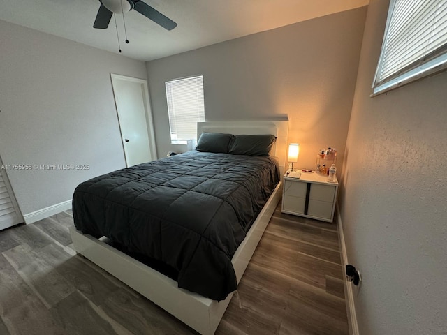 bedroom featuring multiple windows, wood finished floors, baseboards, and ceiling fan