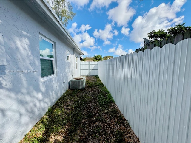 view of yard featuring central AC unit and a fenced backyard