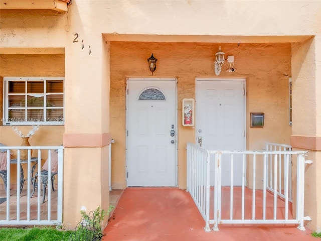 entrance to property featuring stucco siding