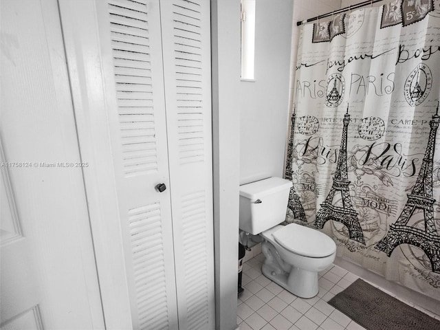 full bathroom with a closet, tile patterned flooring, toilet, and a shower with curtain