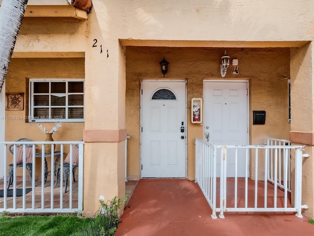 property entrance featuring stucco siding