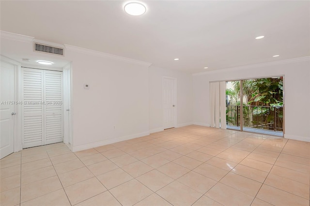 unfurnished room featuring baseboards, visible vents, and crown molding