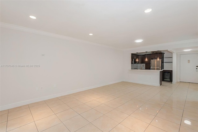 unfurnished living room with ornamental molding and baseboards