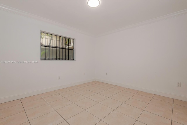 spare room featuring baseboards and ornamental molding