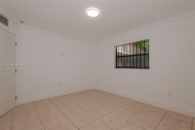 unfurnished room featuring light tile patterned floors, baseboards, and ornamental molding