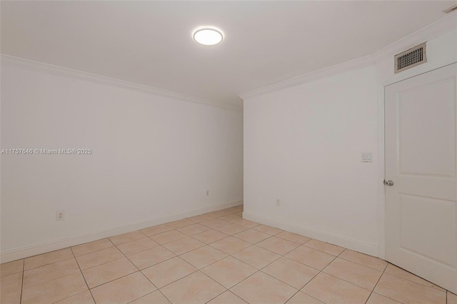 spare room featuring ornamental molding, visible vents, and baseboards