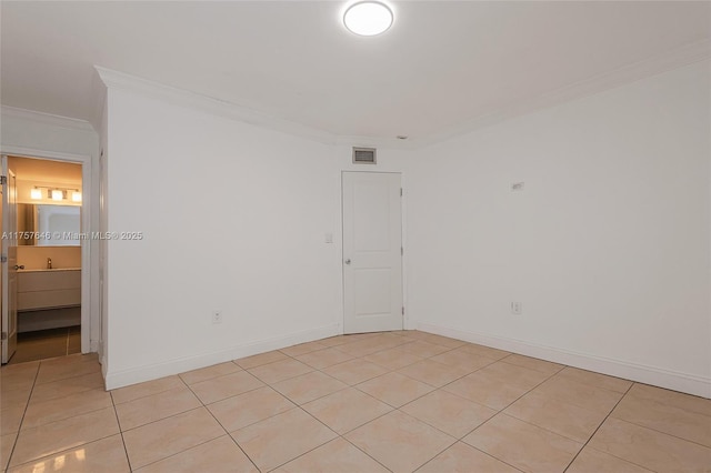 empty room featuring visible vents, crown molding, baseboards, and light tile patterned floors