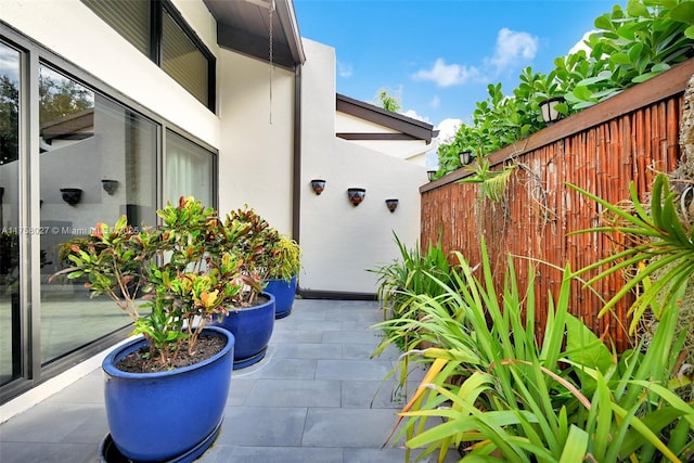 exterior space with a patio, a fenced backyard, and stucco siding