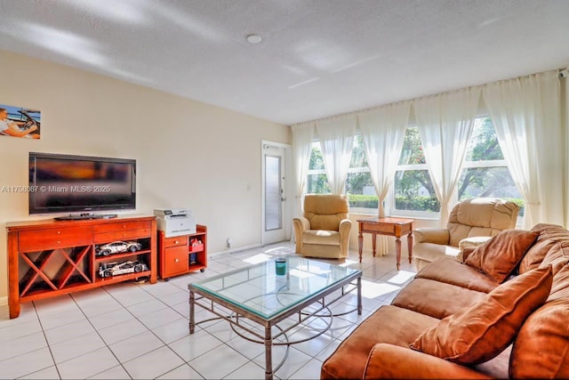 living room with light tile patterned floors and a textured ceiling