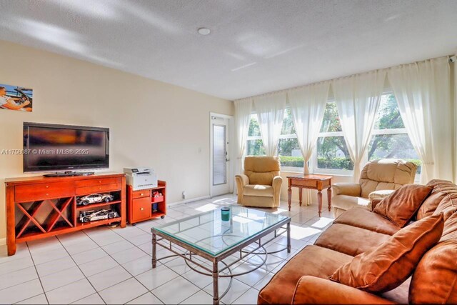 850 NE 12th Ave Unit 210, Hallandale Beach, FL 33009 - living room with a textured ceiling and light tile patterned floors