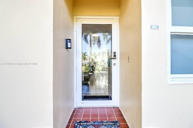 entrance to property featuring stucco siding