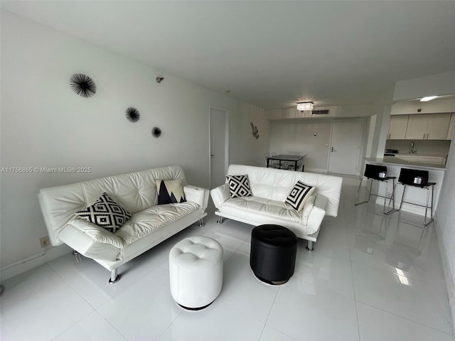 living area featuring visible vents and light tile patterned flooring