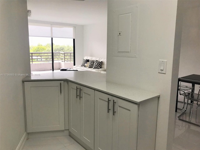 kitchen with gray cabinets, electric panel, and light countertops