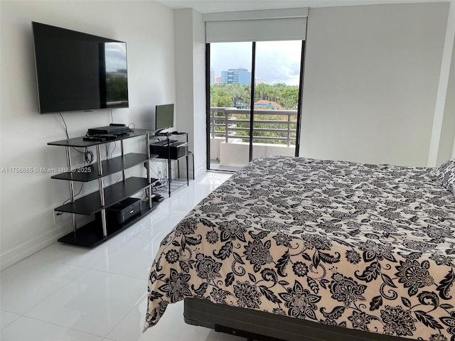 bedroom featuring light tile patterned floors, access to outside, and baseboards