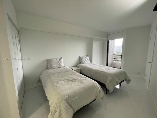 bedroom featuring baseboards and light tile patterned floors