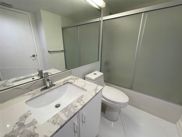 bathroom with enclosed tub / shower combo, vanity, toilet, and tile patterned floors