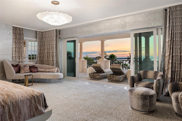 bedroom featuring access to outside and a notable chandelier