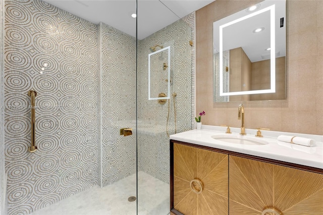 bathroom featuring a walk in shower and vanity