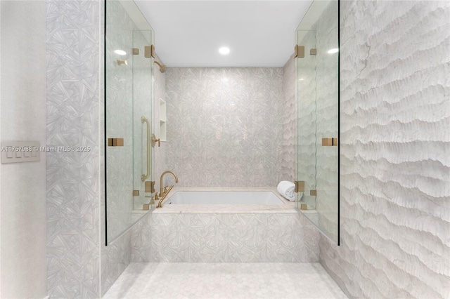 bathroom featuring a garden tub and a shower with door