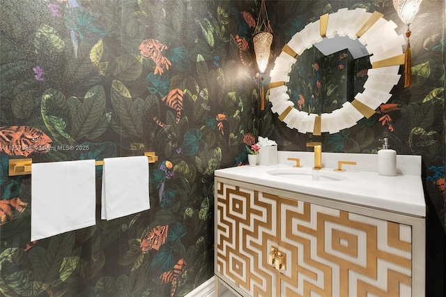 bathroom featuring vanity and wallpapered walls