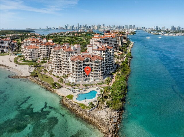 aerial view featuring a water view, a view of city, and a beach view