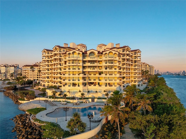 view of building exterior with a view of city and a water view