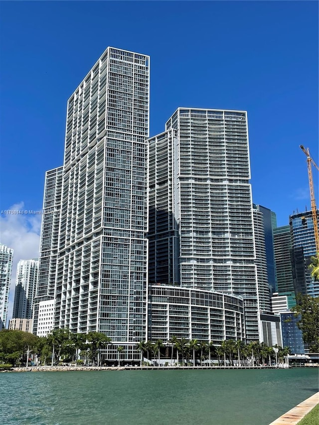 view of building exterior featuring a view of city and a water view