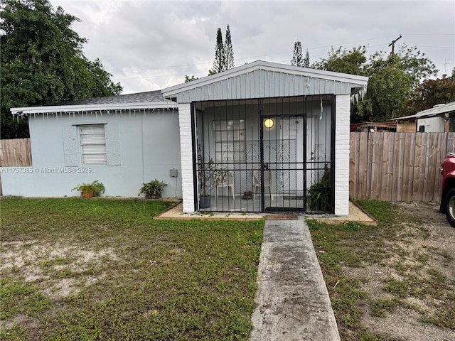 exterior space with a front yard and fence