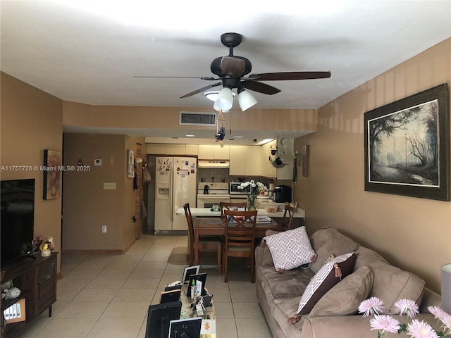 living area with light tile patterned floors, ceiling fan, and visible vents