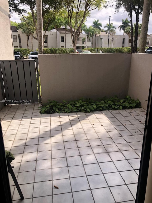 view of patio with a residential view, a gate, and fence