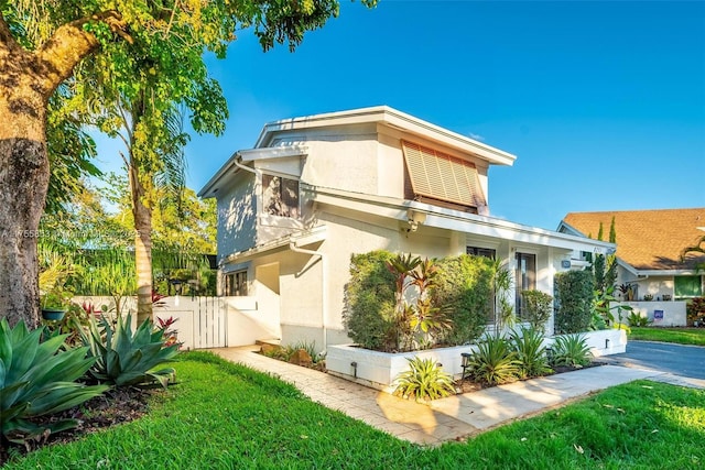 view of property exterior with fence and stucco siding