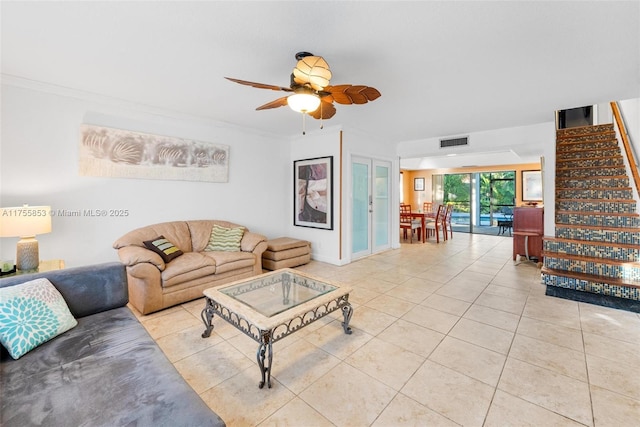 living area with ornamental molding, stairway, tile patterned flooring, and visible vents