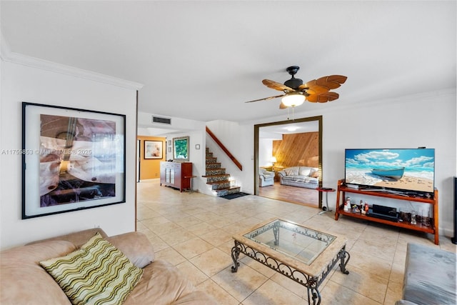 living room with visible vents, a ceiling fan, ornamental molding, stairs, and light tile patterned flooring